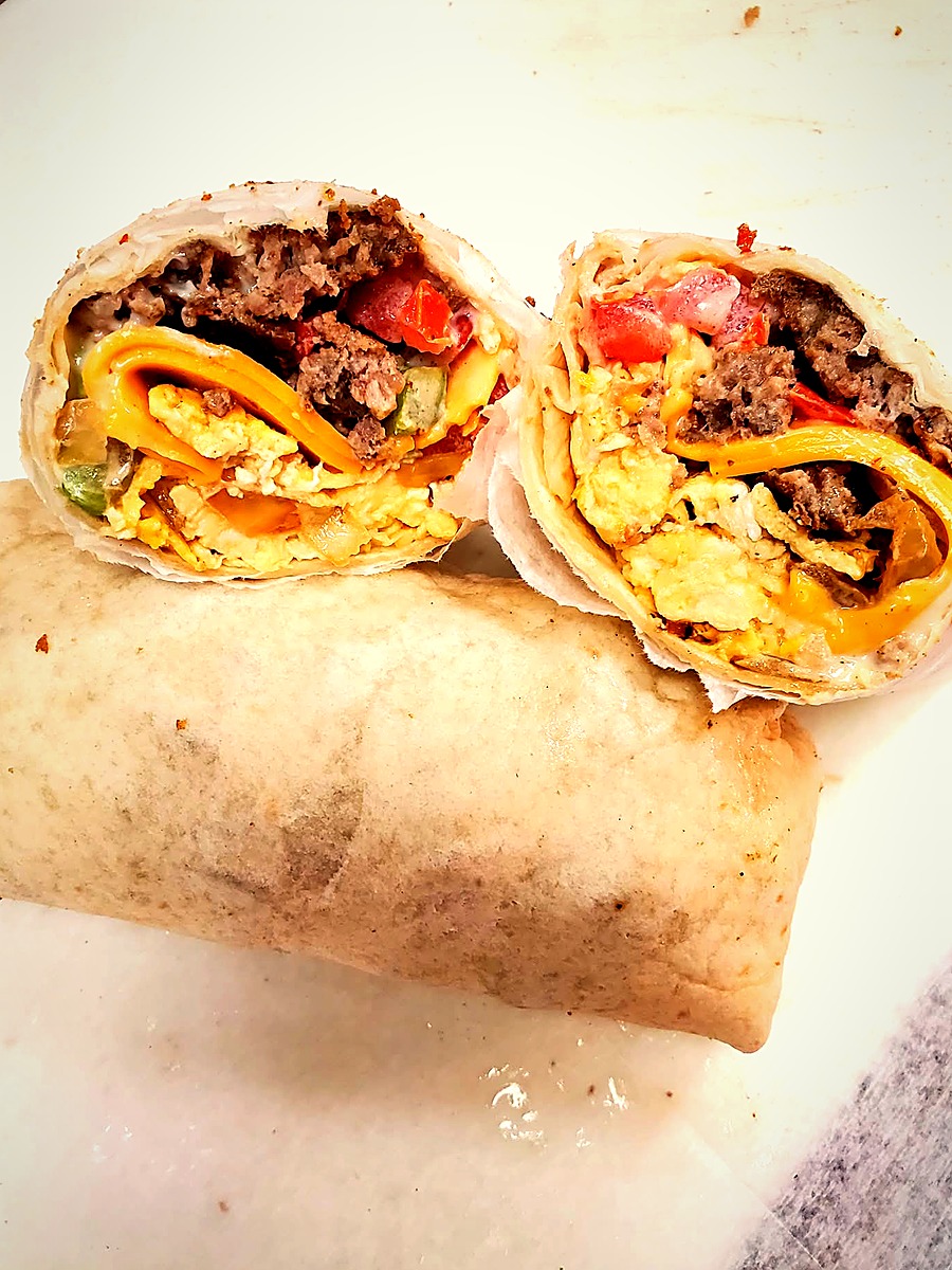 Tony's breakfast wrap sliced in half, packed with eggs, bacon and cheese